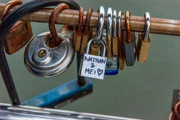 Rusting padlocks on a railing as love tokens.
