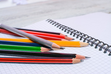 Colorful pencils on white sheet of paper