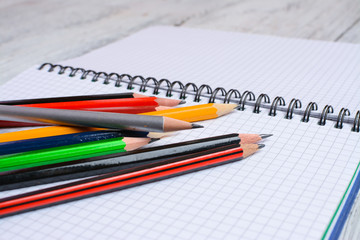 Colorful pencils on white sheet of paper