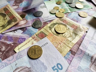 Ukrainian money hryvnia UAH. Banknotes of Ukraine with selective focus on metal coins 