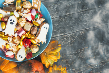 Halloween holiday card - candy bowl with candy and halloween cookies Trick or Treat