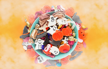 Halloween holiday card - candy bowl with candy and halloween cookies Trick or Treat