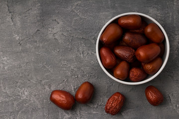 Juicy dates on a concrete surface,  a healthy alternative to sweets concept