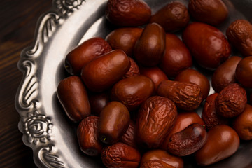 Dried date fruits in silver bowl , close up . Ramadan background. Ramadan kareem.