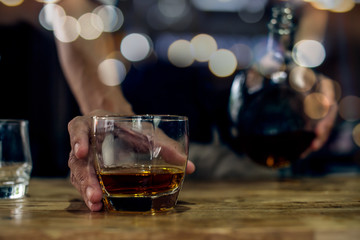 Barman pouring whiskey whiskey glass beautiful night