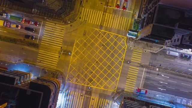 Transportation or technology concept : 4K UHD Aerial top down view zoom out hyper lapse over Urban Crossing road in Sham Shui Po near Mong kok shopping street night market Hong Kong at night.