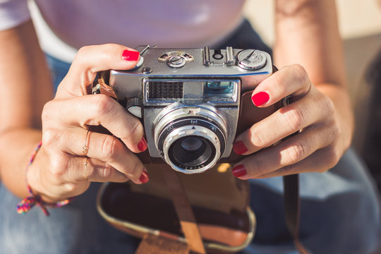 Woman's hands holding an old analog photography camera