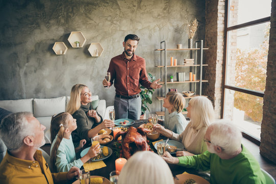 Portrait of nice cheery big full family brother sister granddaughter grandson enjoying feast tradition dad saying grateful toast congratulate daydream in modern loft industrial style interior house