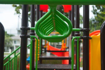 Fototapeta na wymiar Hang the green bar exercise at outdoor playground.