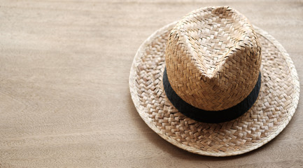 Fototapeta na wymiar Straw hat put on wooden background and copy space