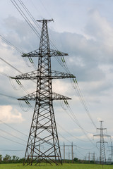 Power lines during a beautiful sunset. Transportation of electricity through the beautiful landscapes of the world