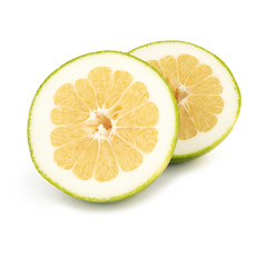 Green grapefruit / pomelo with a slice with juicy yellow pulp isolated on a white background. Top view.