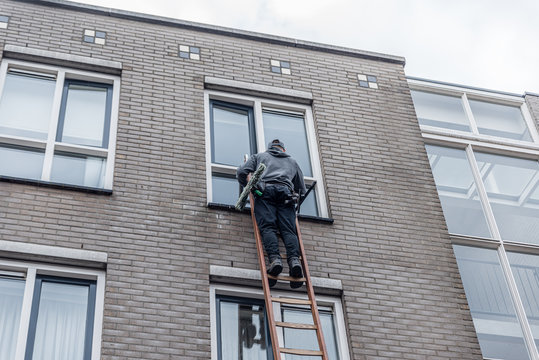 Man On A Ladder Stock Photo - Download Image Now - Ladder, Window Washer,  Danger - iStock