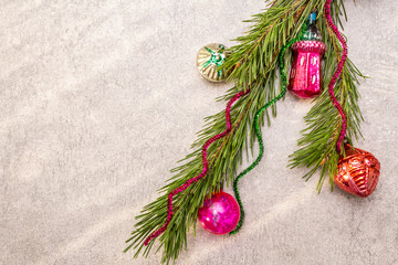 Vintage Christmas tree toys. New Year holiday concept. Evergreen pine branch, sunny rays