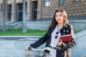 student with a book at the bike