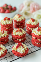 Miniature Red Velvet Cakes with cream cheese frosting and fresh strawberry topping
