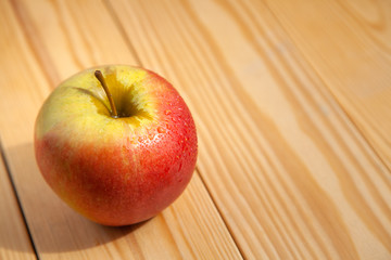 big apple on wooden background. copy space