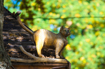 Wood sculpture cat with glasses