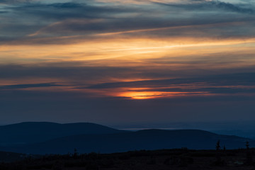 sunset with clouds and colorful sky from Snezne jamy in Krkonose mountains on czech - polish borders