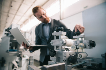 Manager checks machines at the factory. Inspector checks a factory.