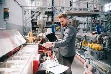 Manager checks machines at the factory. Inspector checks a factory.