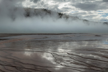 Sky reflected in a steaming thermal pool