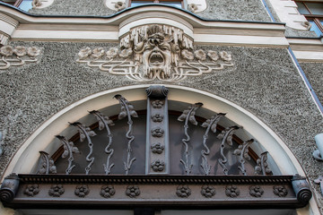 Ornate facade of a house with a head of a man in art nouveau style in Riga, Latvia, Baltic States,...