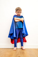 lost little superhero child with arms folded thinking about sadness