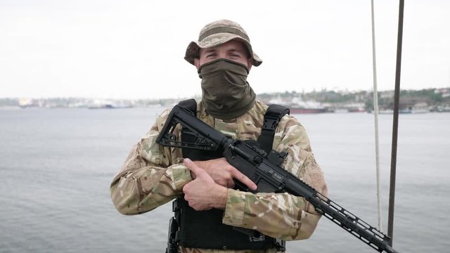 Special force unit on the board of vessel, holding M16 rifle.