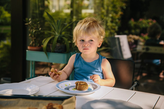 Little boy having a snack outside