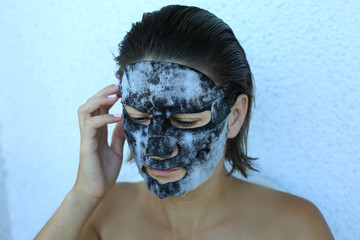 Bubble oxygen charcoal black mask. Face treatment. Popular sheet face mask anti blemish and acne. Famous beauty trend.