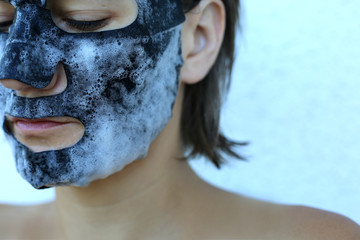 Bubble oxygen charcoal black mask. Face treatment. Popular sheet face mask anti blemish and acne. Famous beauty trend.
