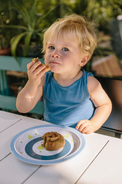 Little boy having a snack outside