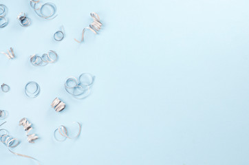 Festive blue background with silver spirals.