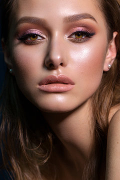 Close up portrait of beautiful young woman with professional makeup, perfect skin, colorful eyeshadows.