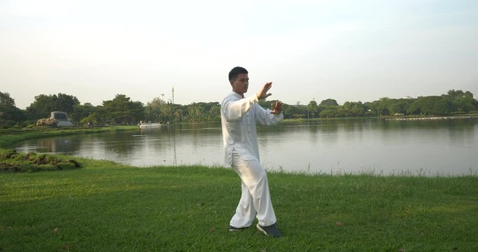 Asian man working out with Tai Chi in the morning at the park, Chinese martial arts, healthy care for life concept part16.