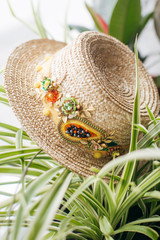 Beautiful straw boater decorated with a brooch in green leaves