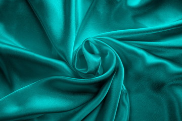 turquoise silk delicate fabric, twisted and folded in drapery