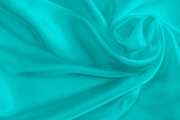 turquoise silk delicate fabric, twisted and folded in drapery