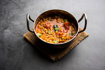 Chana Dal fry or Split Bengal Gram tadka served in a bowl or pan, selective focus