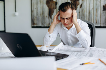 Fototapeta premium Frustrated stressed business man in an office