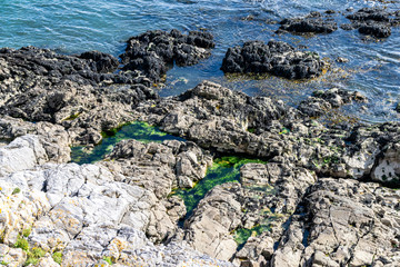 Cliffs and rock formations into the Atlantic Ocean and English Channel in Plymouth, Devon, UK