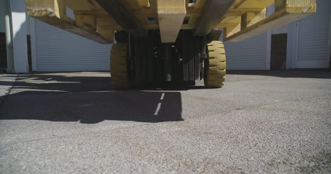 Close up shot, forklift driver loading empty pallet, 4K.