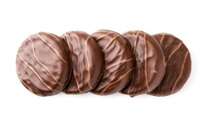 Cookies in chocolate lies in a row on a white. The view of the top.