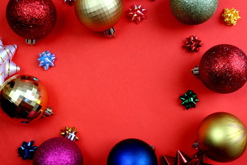 Christmas toys in the form of a frame are located on a red background.