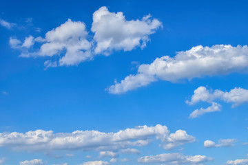 Obraz na płótnie Canvas White clouds can be seen in a bright blue sky.