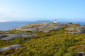 Tranquil Landscape with a Red and White Lighthouse in Norway