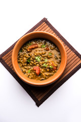 Whole Green Moong Dal fry / Whole Mung bean Tadka served in a bowl. selective focus