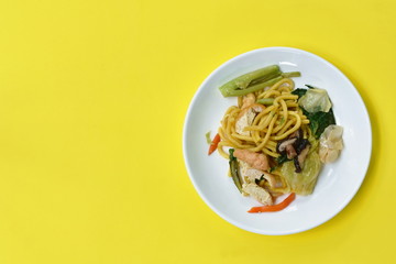 stir fried yellow noodles with cabbage and tofu vegetarian food on dish