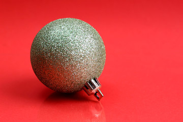 green christmas toy on red background